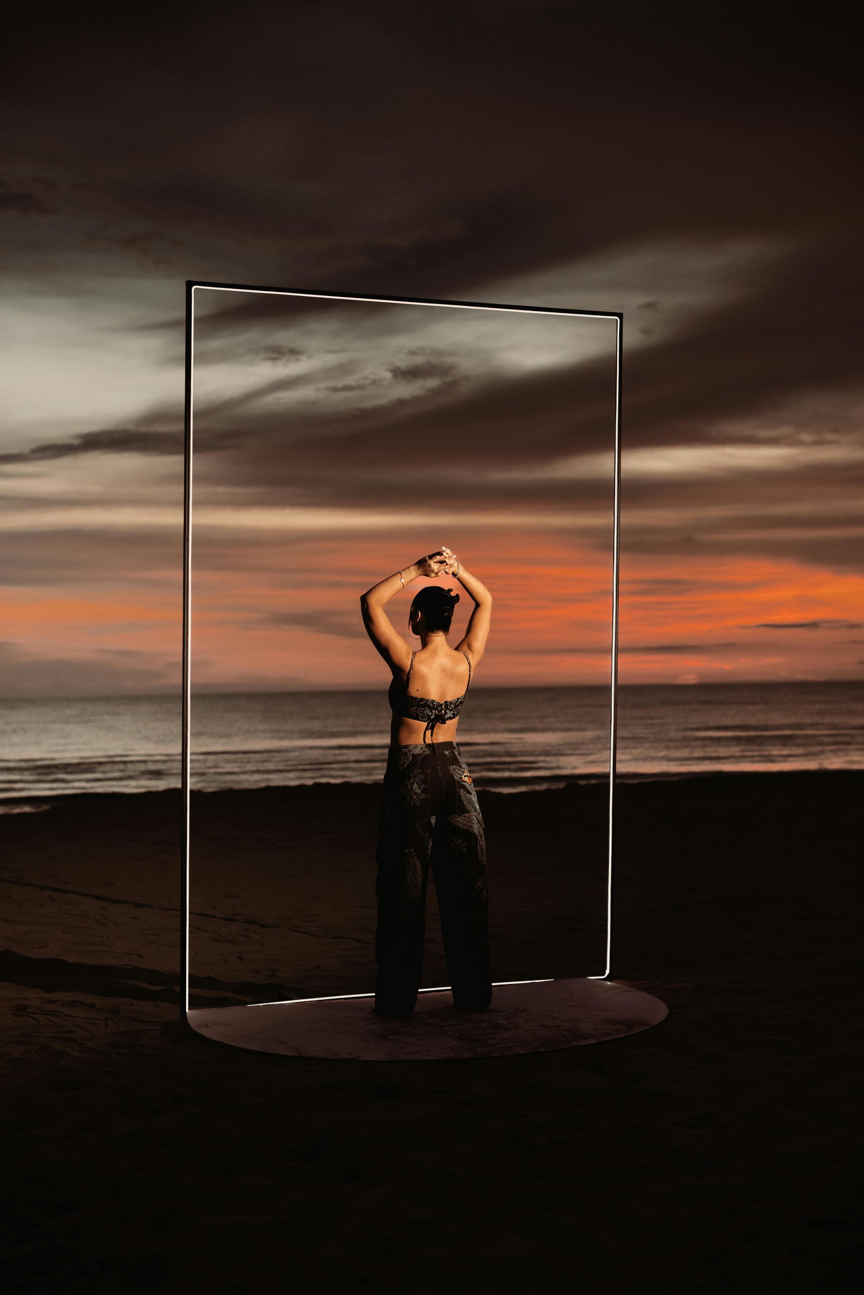 Woman standing in front of the ocean, contemporary art