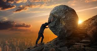 Man rolling boulder up a hill